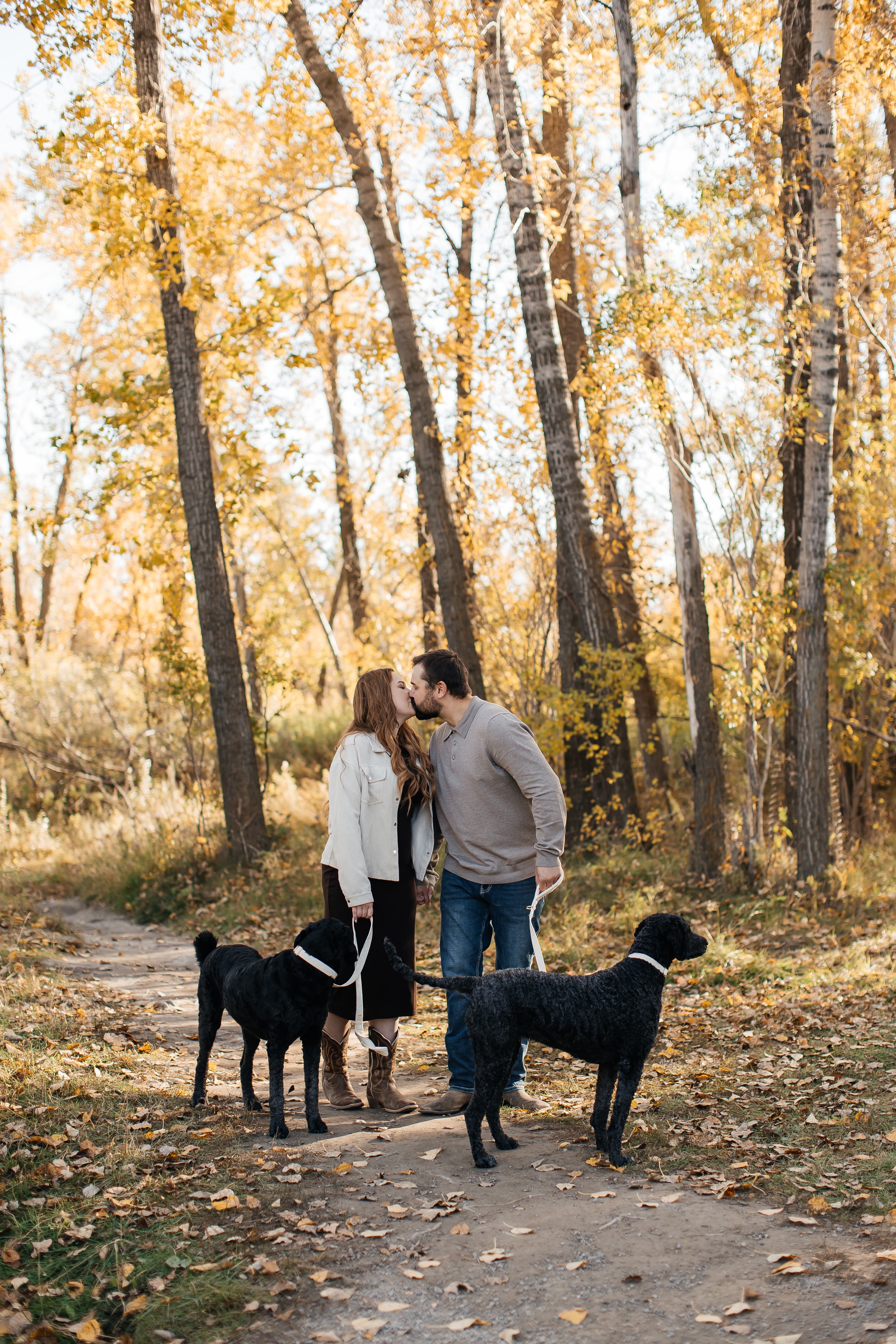 Victoria and Riley with their dogs in a beautiful autumn forest